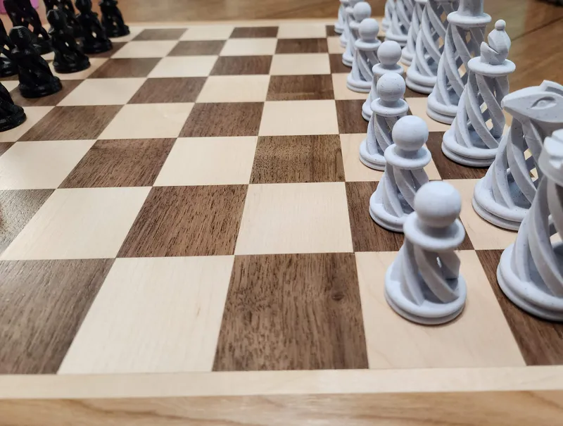 3D-printed spiral chess pieces on a handmade walnut, maple, and cherry chessboard